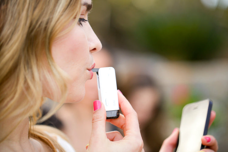 Woman blowing into a breathalyzer